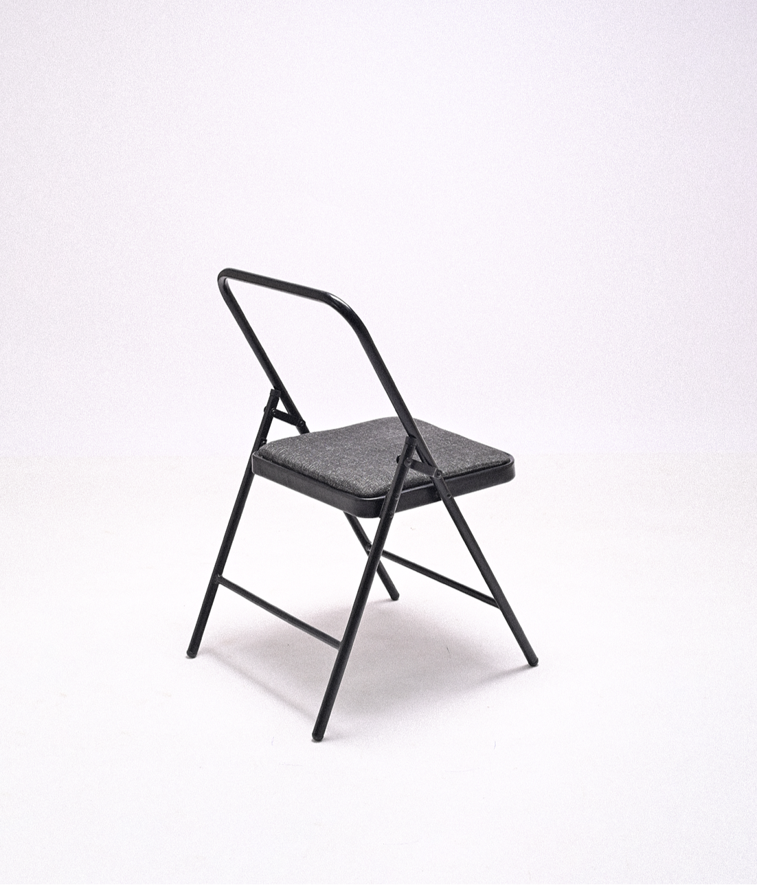 Black metal folding chair with a cushioned seat on a white background